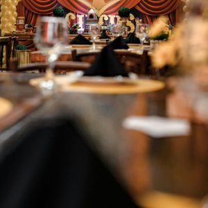 Elegant circus-themed party setup with detailed decor and tables indoors.